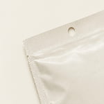 A three-side seal bag corner shows a clean tear notch and round hanging hole.