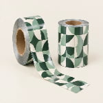 Two rollstock film reels show visible cardboard cores and glossy film partly unwound across the surface.